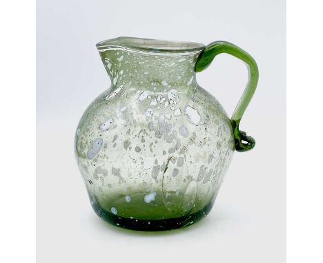 A Nailsea type glass jug, circa 1800, pale green with opaque white mottling, height 15cm.Provenance: From the Estates of June