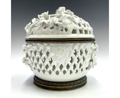 A white glazed pierced basket and cover, Continental, probably 19th century, with trellis design and gilt metal mounted foot 