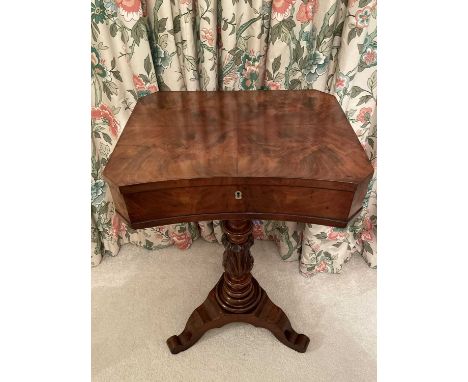 A George IV mahogany work table, with concave fronted hinged top containing lidded compartments and raised on a turned and le