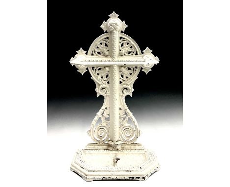 A Victorian painted cast iron stick stand with a ringed cruciform shape embellished with scroll and stylised flower decoratio