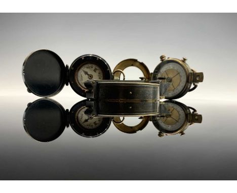 A lacquered brass compass made by Stanley London, with a brass card dial compass with lift up brass sight, and another brass 