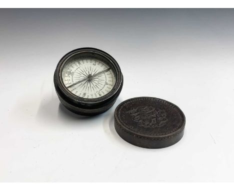 A late Victorian dry card brass compass by T. Armstrong &amp; Bro. in a leather worked case the lid embossed with a hunter ri