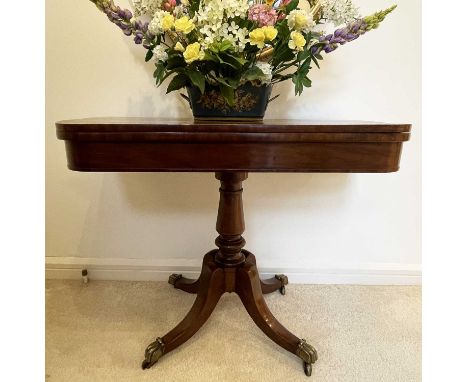 A William IV mahogany fold top card table, on a baluster turned pillar and four brass capped out splay legs, height 74cm, wid