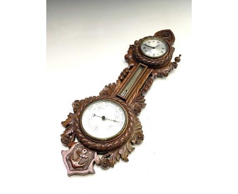 A late Victorian walnut clock/barometer, with flower, foliate and anchor carved decoration, with eight-day timepiece, thermom