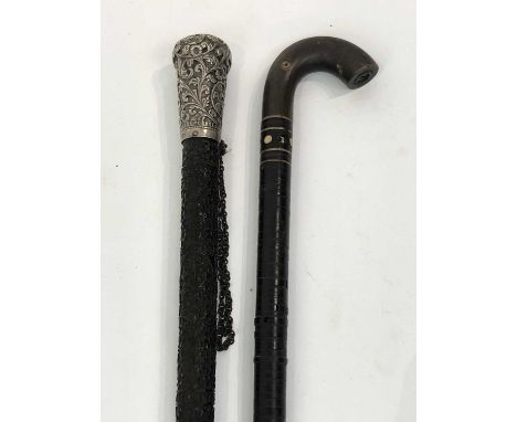 An Indian carved ebony walking stick, circa 1880, with repousse decorated white metal knop, together with a baleen disc secti