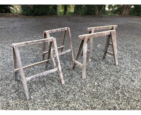 A pair of carpenters trestle saw horses, and a pair of folding trestle saw horses, height 73cm width 91cm.Provenance: From th