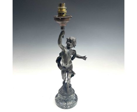 After Auguste Moreau, a bronzed lamp, modelled as a cherubic youth supporting the torch in his raised hands, on a green marbl