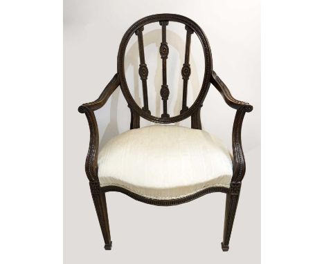 An Edwardian Hepplewhite style mahogany open armchair with oval back and beaded and fluted carved decoration.Alan Bennett (19