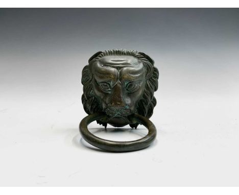 A cast brass lions head door knocker, length 15cm.