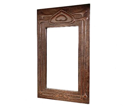 A Glasgow School Arts and Crafts copper framed mirror, circa 1900, embossed with heart motifs and sinuous tendrils, labelled 