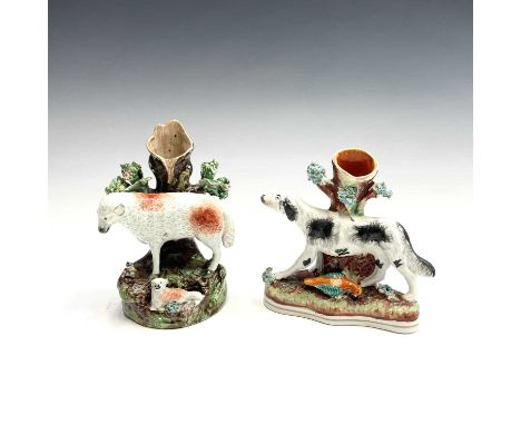 A Staffordshire spill vase, circa 1860, as a gundog, with a bird at his feet, width 14cm, together with an early 19th century