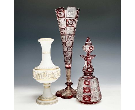 A Bohemian red flash glass vase, 19th century, of trumpet form, height 35cm, together with a similar decanter and stopper, an