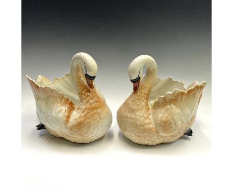 A pair of Staffordshire pottery swan jardinieres, circa 1900, with coloured detail, length 28cm.Provenance:Alan Bennett (1930