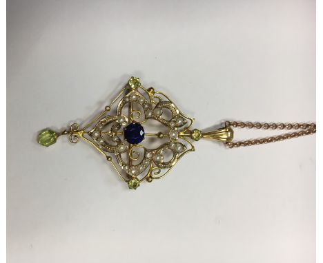 SAPPHIRE, PEARL AND PERIDOT SET HOLBEIN
of pierced form, with a central brilliant cut sapphire, with seed pearl set foliate m