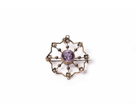 EDWARDIAN AMETHYST AND SEED PEARL HOLBEIN
of scrolling openwork form, with a central oval amethyst surrounded by seed pearls,