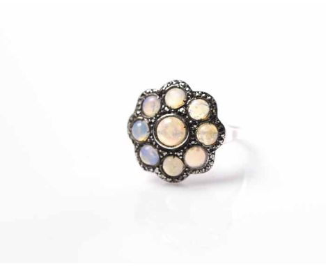 OPAL CLUSTER RING
the central round cabochon cut opal surrounded by smaller cabochon cut opals, in marcasite setting, unmarke