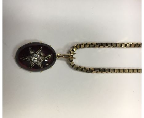 VICTORIAN CABOCHON GARNET AND DIAMOND PENDANT
the oval cabochon garnet overlaid with a star shaped old cut diamond set sectio