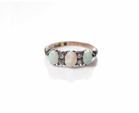 OPAL AND DIAMOND RING
set with three oval cabochon cut opals interspersed with four brilliant cut diamonds, marked for eighte