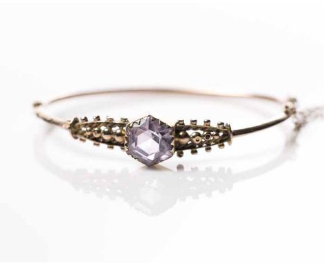 EDWARDIAN NINE CARAT GOLD AMETHYST BANGLE
set with large faceted amethyst measuring approximately 10mm across, marked for nin