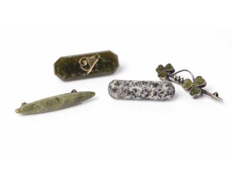 FOUR HARDSTONE BROOCHES
comprising of a clover design brooch, an octagonal green stone brooch with harp decoration, an oblong