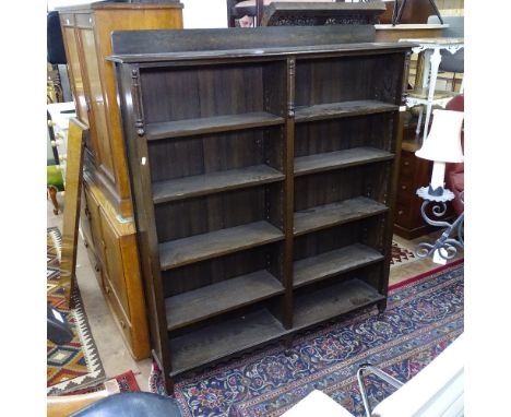 An Edwardian oak open bookcase with 8 adjustable shelves, W135cm, H158cm, D27cm, shelf depth 21cm 