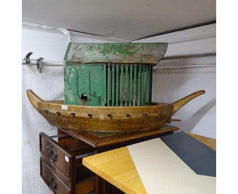A stained wood boat hull, and a Vintage painted wood birdbox 