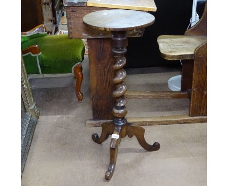 A  rosewood torcher stand with a barley twist column and tripod legs, W31cm, H73cm 