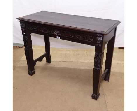 A 1920s rectangular oak console table, with lion mask carved frieze drawer (missing raised back panel).The side table is in f