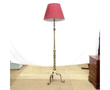 A turned brass standard lamp on tripod base, and a red fluted shade, lamp height to top of bayonet fitting 139cm 