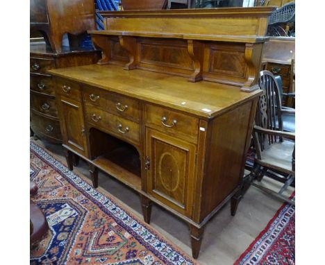 A late Victorian mahogany and satinwood-banded sideboard, with a raised shaped shelf panelled back, with 4 short drawers and 