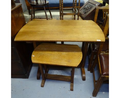 A Heals oak Arts and Crafts bow-end table, on quadruple chamfered legs, L104cm, H76cm, D65cm, and a matching lamp table, W64c