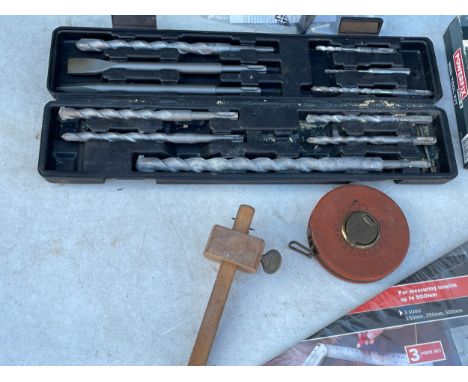A quantity of tools. Try Square Set. Mini tool kit. Staple gun. Large drill bits in case. Face shield. Vintage measuring tape
