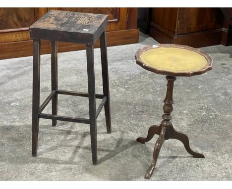 A leather top wine table and vintage stool. 