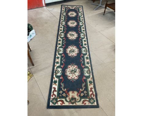A large wool runner rug. 330x70cm 