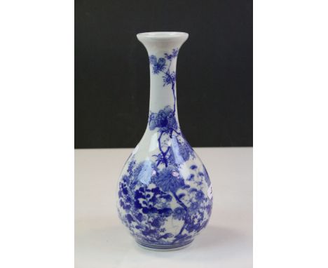 Japanese blue &amp; white ceramic Bottle vase with Floral decoration &amp; signed to base, stands approx 23.5cm