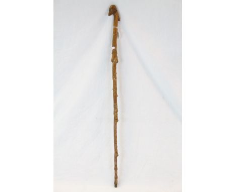 Vintage folk art walking stick with carved bearded man handle and dog head to verso 