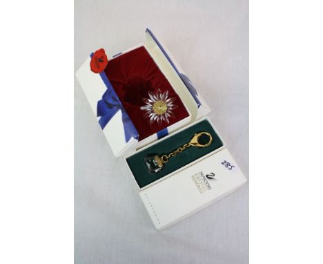 Boxed Swarovski key chain with "Pocket Book" plus a boxed Swarovski "Daisy"