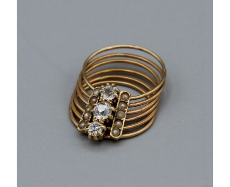 Articulated multi ring fiddle ring, unmarked but tests as high grade gold, set with seed pearls and three old European cut di