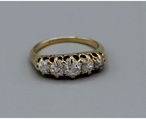 A five stone diamond ring set with old mine cut diamonds, principle stone approx 4 x 3.5mm. Hallmark obscured, 18ct gold, 3.7