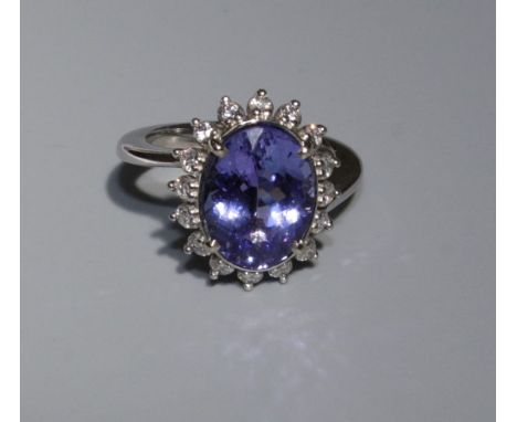 A very fine Tanzanite cocktail ring, set in white metal (tests as 14ct white gold), stone 5.18cts with GIA report, with sixte