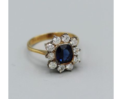 A royal blue sapphire dress ring in 18ct yellow gold, blue stone measuring 8 x 6mm with ten x 0.10ct diamonds (est) gross wei