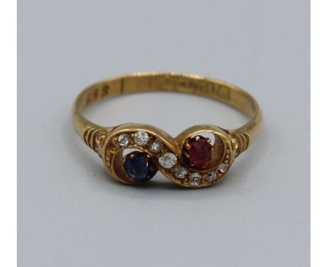 A diamond, ruby and sapphire scroll ring in 18ct gold