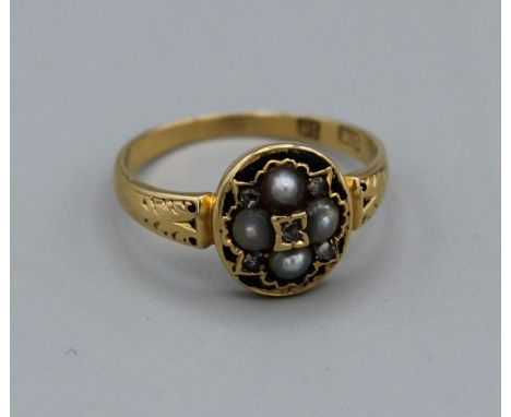 An 18ct stamped yellow metal mourning ring set with five rose cut diamonds and four seed pearls with residual enamel (in blac