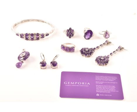 A large collection of silver amethyst jewellery, including a large solitaire dress ring, a floral cluster, a pear cut amethys