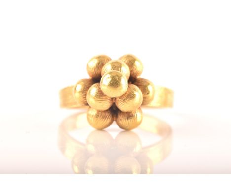 A Chinese yellow metal ring, with a ten-ball pyramid design, size K, Chinese hallmarks to interior of shank.6.1 gramsTests as