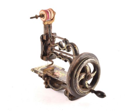 A James G Weir 'The Globe' hand-cranked sewing machine, circa 1870s, in black finish with gilt and flower painted decoration,