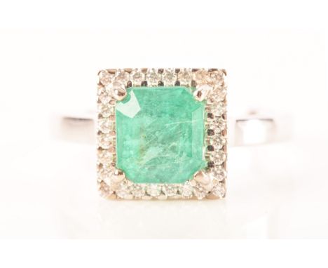 A 18ct white gold emerald and diamond ring, set to centre with a hexagonal cut emerald with an approximate weight of 0.60 car