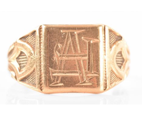 An 18ct yellow gold signet ring, with engraved initials and carved detailing to shoulders, size T, accompanied by box.7.0 gra