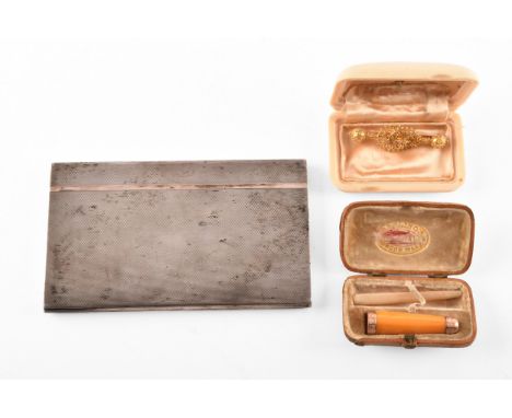 A yellow metal bar brooch with ornate filigree detail, together with a 9ct gold mounted amber cheroot holder in a fitted case