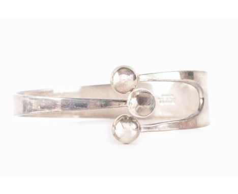 A 1960's Norwegian silver three ball bangle by Anna Greta Eker, 7cm diameter.40.4 grams.